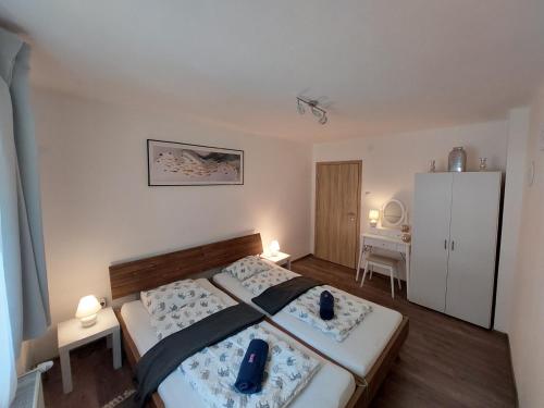 a bedroom with a bed and a white refrigerator at Villa Kärnten Radenthein in Radenthein