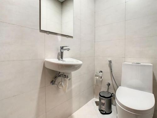 a white bathroom with a sink and a toilet at Key View Hera Tower in Dubai