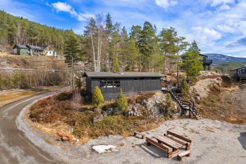 a house on a hill with a road at Lem Cabins in Sogndal
