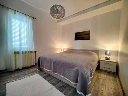 a bedroom with a large bed and a window at Apartments Dajana in Orebić