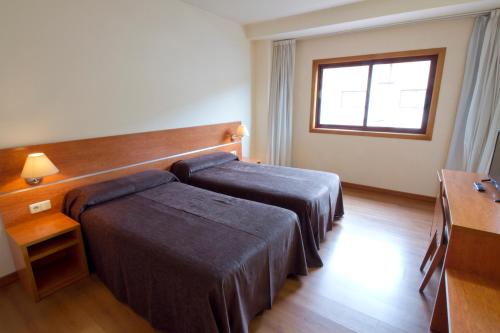 Postel nebo postele na pokoji v ubytování Hotel Torques