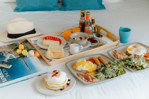 a breakfast tray with food on a bed at Royal Beach View in Pattaya South