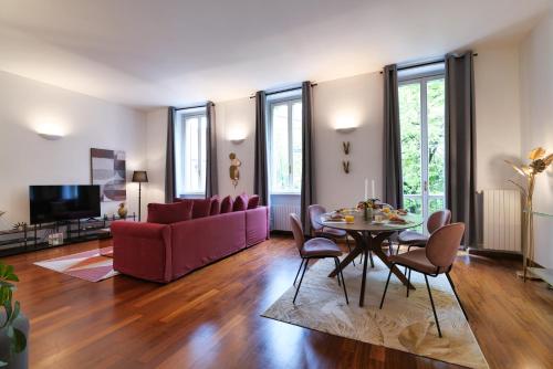 - un salon avec un canapé rouge et une table dans l'établissement Sweet Inn - Osti, à Milan