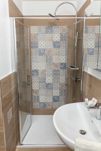 a bathroom with a shower and a sink at Peter & Dove's House in Mola di Bari