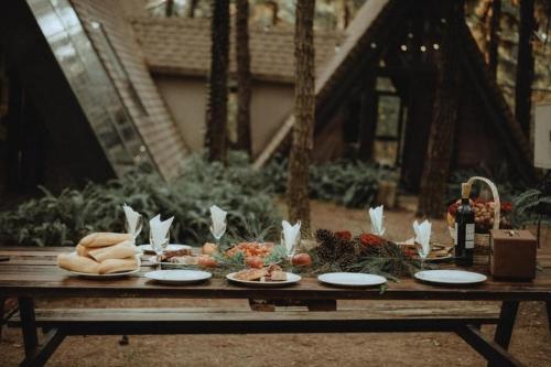 a wooden table with plates of food on it at La Pineta Sóc Sơn - Venuestay in Sóc Sơn