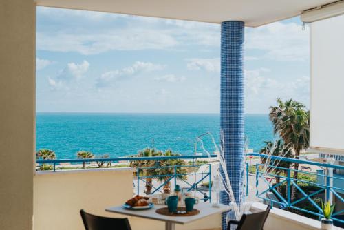 a view of the ocean from the balcony of a resort at Dimora Donna Matilde in Polignano a Mare