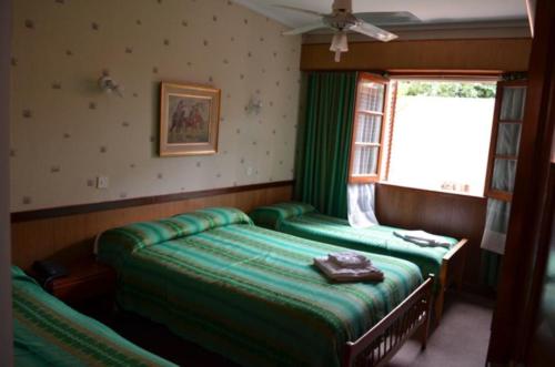a bedroom with two beds and a window at Palace Hotel in Miramar