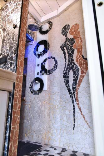 a tile wall with a sign on the side of a building at L'Angolo di Gaudì, casa Milà in Putignano