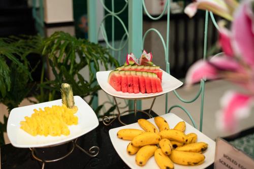 three plates of food on a table with bananas at Hoi An Ivy Hotel in Hoi An