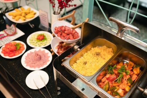 a buffet with a lot of food on a table at Hoi An Ivy Hotel in Hoi An