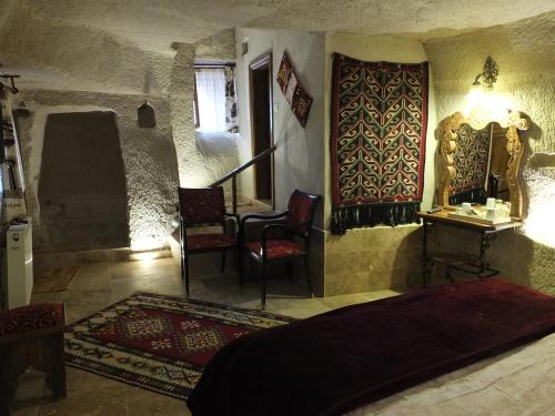 a bedroom with a bed and a table and chairs at Anatolia cave hotel Pension in Goreme
