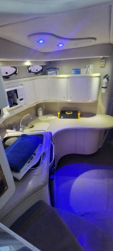 an inside view of an airplane cabin with blue lights at Billionaire Yach Resort - Muelle Marina Puerto Cancun in Cancún