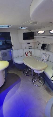 a small room with a table and couches in a vehicle at Billionaire Yach Resort - Muelle Marina Puerto Cancun in Cancún