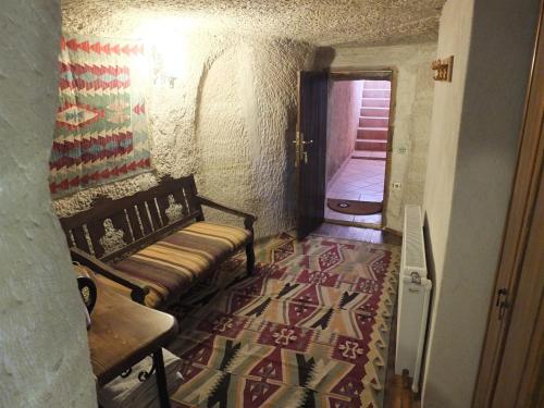 a living room with a bench and a rug at Anatolia cave hotel Pension in Goreme