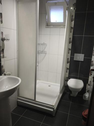 a bathroom with a shower and a toilet and a sink at ELSİRA APART in Side