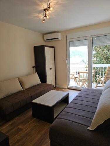 a living room with a couch and a table at Apartment Mimi in Herceg-Novi
