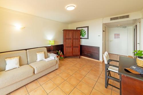 a living room with a couch and a table at Village Pierre & Vacances Sainte Anne in Sainte-Anne