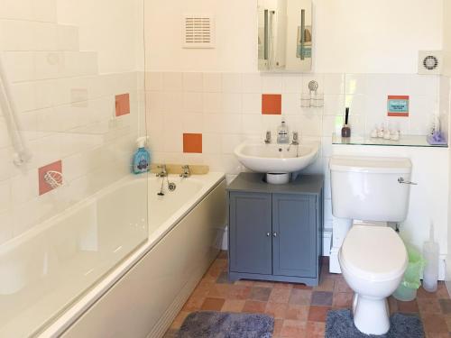 a bathroom with a toilet and a sink at Horseshoe in Saltfleetby Saint Clement