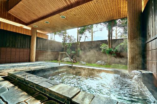 a swimming pool in the middle of a house at glampark Monte Rosa Hyogo in Kamikawa