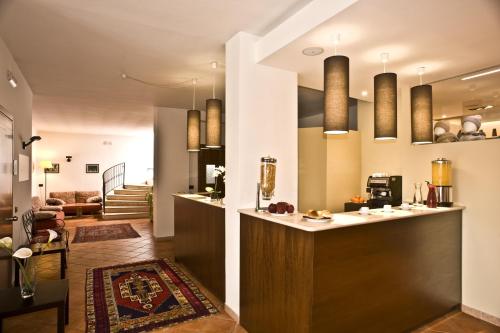 a kitchen with a counter and a living room at Villa Santacroce in San Giovanni Rotondo