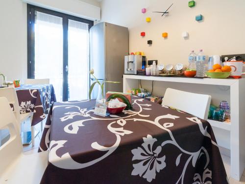 a kitchen with a table with a black and white blanket at Al Molì Affittacamere in Cagliari