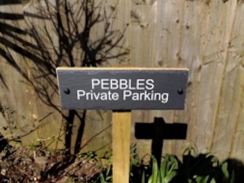 a sign for peebles private parking in front of a fence at Pebbles in Lynton