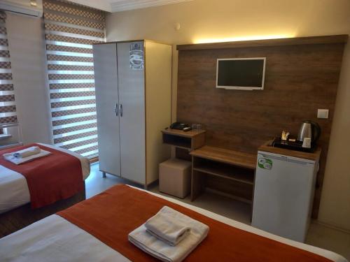Postel nebo postele na pokoji v ubytování ADOR TROIA HOTEL