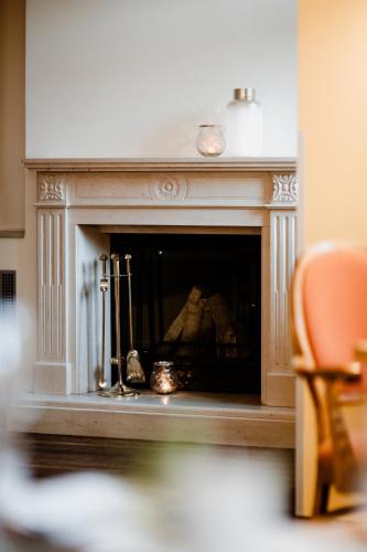 a fireplace with two candles and two utensils at Hotelpark Bodetal mit Ferienwohnungen in Thale