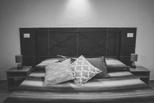 a bedroom with a large bed with pillows on it at L'ANFORA DELLE MURELLE in Torre di Montalto