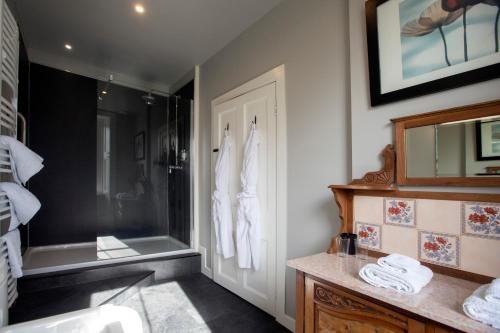 a bathroom with a shower and a sink and a tub at Cardhu Country House in Aberlour