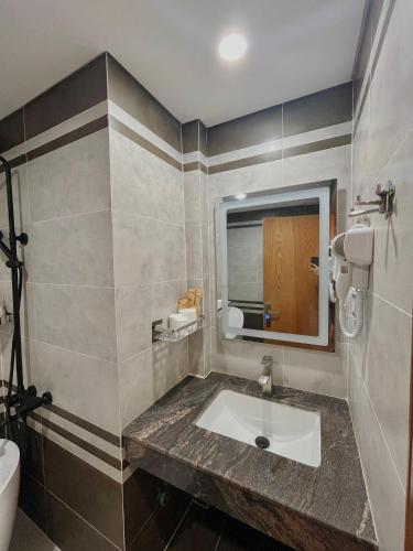 a bathroom with a sink and a mirror at SK BOUTIQUE HOTEL in Phú Quốc