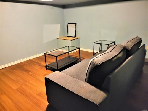 a living room with a couch and a table at Cozy 4 bedroom townhouse - peaceful feel of home in Winnipeg