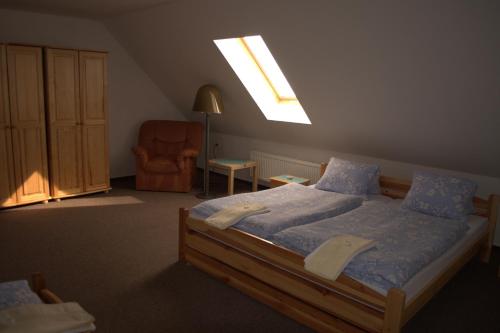 a bedroom with a large bed and a skylight at Hostinec vo Višňovom in Stará Turá