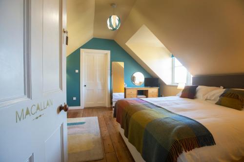 a bedroom with a large bed and a window at Cardhu Country House in Aberlour