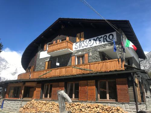 a building under construction with a sign on it at Sasso Nero in Chiesa in Valmalenco