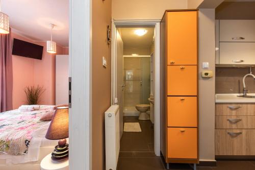 a small room with a bed and a bathroom at Apartman Ruza in Krk