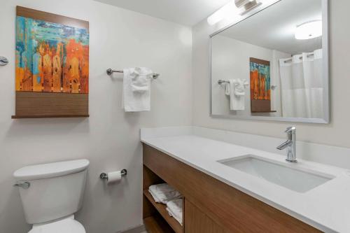 a bathroom with a sink and a toilet and a mirror at MainStay Suites Lexington I-75 in Lexington