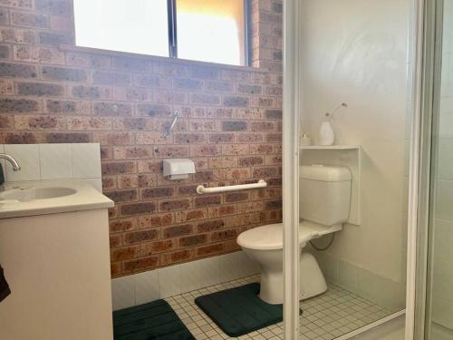 a bathroom with a toilet and a sink at Stay on Lachlan in Cowra