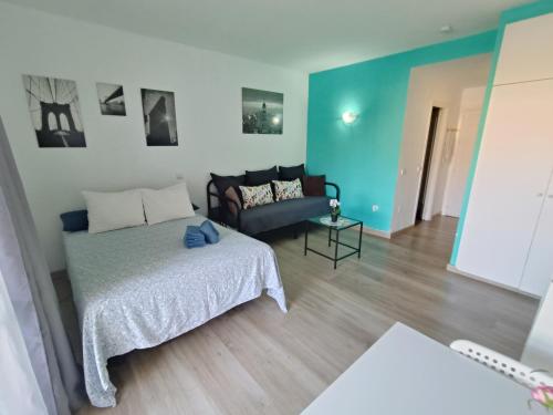 a living room with a bed and a couch at "VIVE BENAL BEACH" estudio gran terraza y parque acuático 1319 in Benalmádena