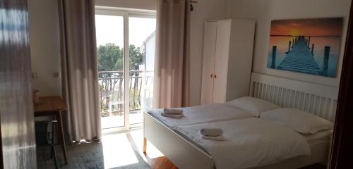 a bedroom with a bed with two towels on it at Summerhouse Duće Omiš in Duće
