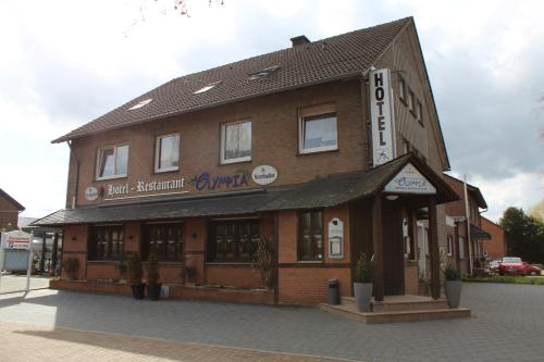 a building with a sign on top of it at Hotel-Restaurant Olympia in Selm