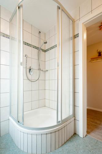 a shower with a glass door in a bathroom at Ferienwohnung Seeute Deern in Westerland