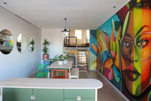 a room with a large colorful painting on the wall at Lion House in Bo Kaap - Number 53 in Cape Town
