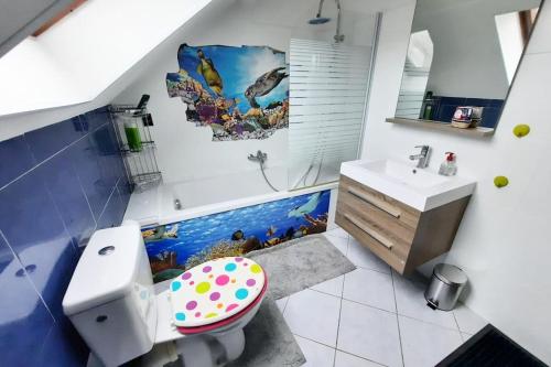 uma casa de banho com um mural de peixe na parede em Villa confortable avec Jacuzzi à Chevannes em Chevannes