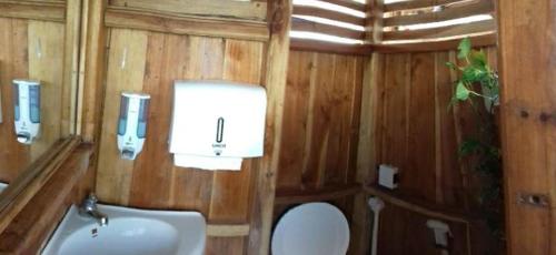 a small bathroom with a toilet and a sink at Komodo Tour 1-6 Pax 2 Days 1Night in Labuan Bajo