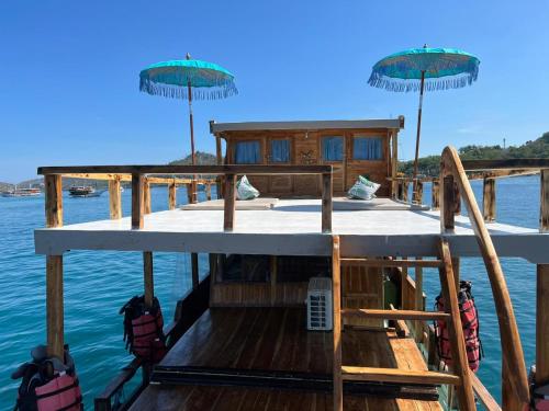 a house on a boat in the water at Komodo Tour 1-6 Pax 2 Days 1Night in Labuan Bajo
