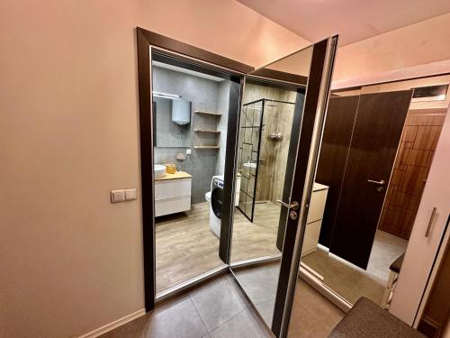a bathroom with a mirror and a toilet at Allegro Home, Apartment by LMG in Sofia