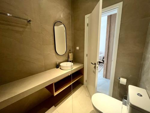 a bathroom with a sink and a mirror at Latchi Marina View in Polis Chrysochous