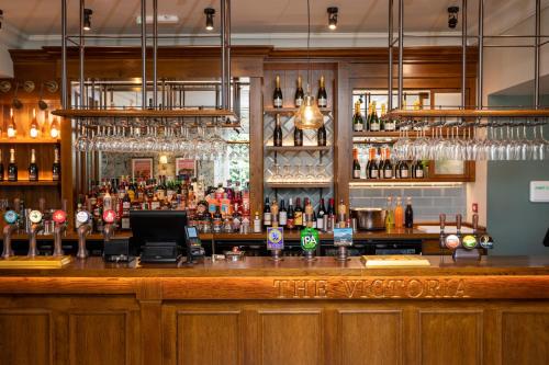 a bar with a lot of bottles of alcohol at Victoria Hotel by Chef & Brewer Collection in Menai Bridge