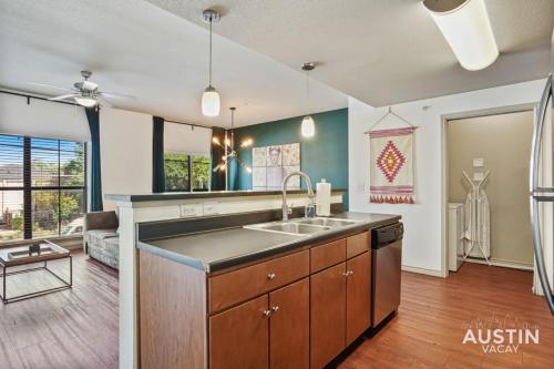 a kitchen with a sink and a living room at Stylish 4BR with Smart TV and Free Garage Parking in Austin